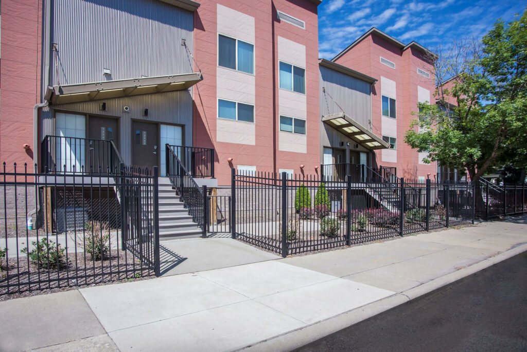 Detail of townhome entries with steel railings and landscaped front yards
