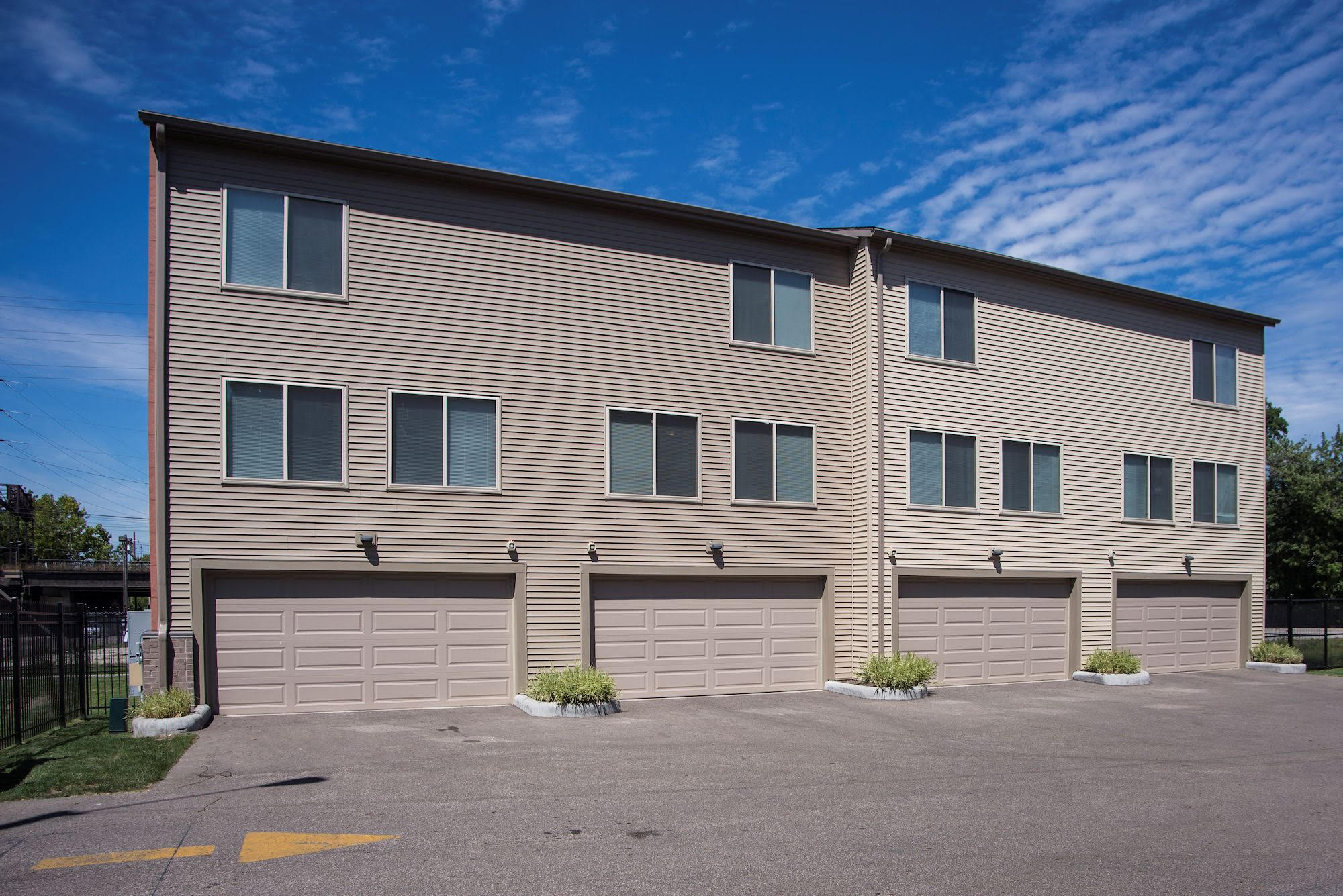 Rear elevation with attached two-car garages and dedicated drive court