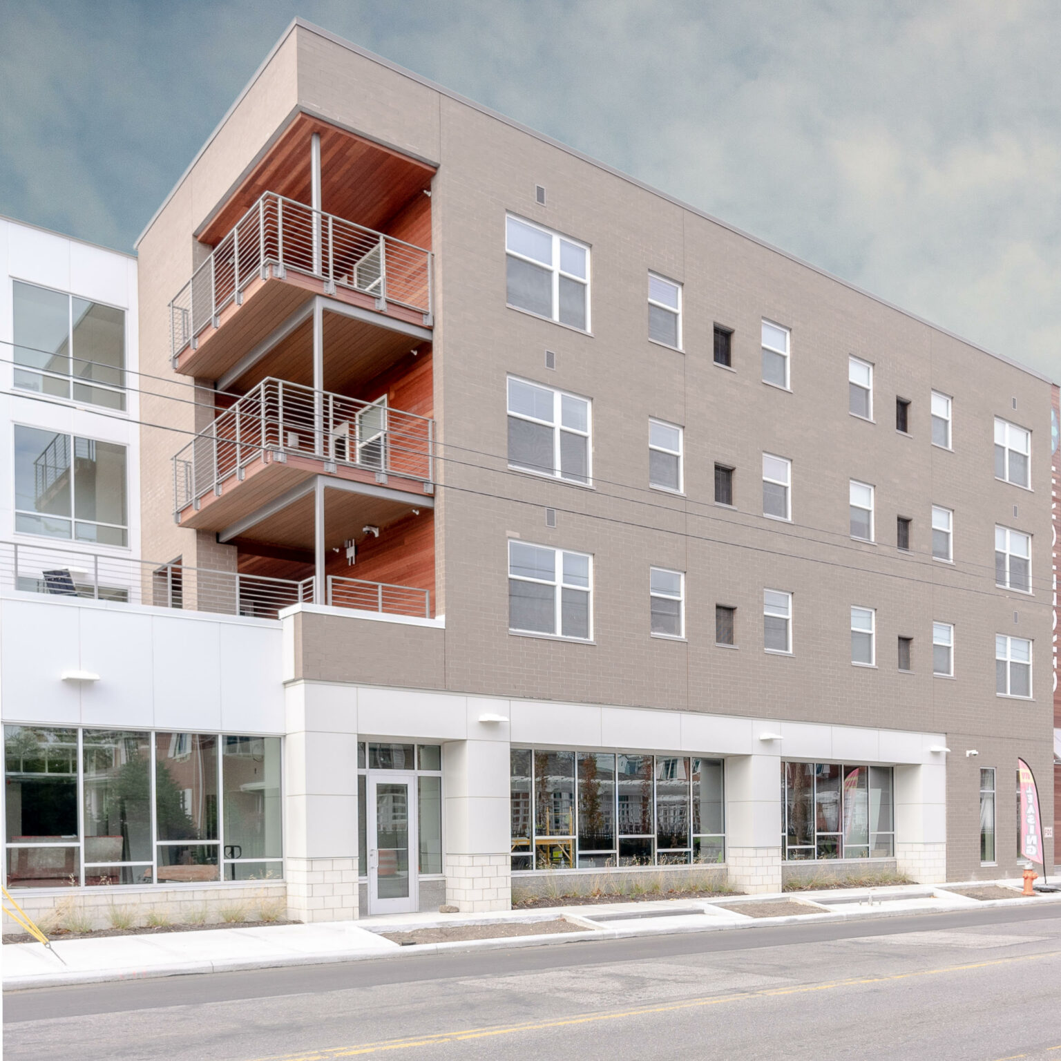 Corner balconies with cedar soffits and steel cable railings
