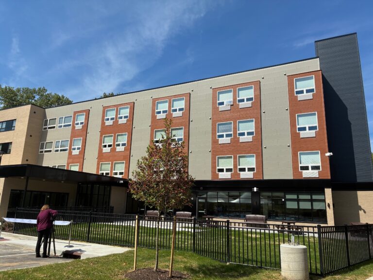 Hitchcock Center for Women — front elevation with red brick volumes and ground-floor community space
